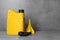 Yellow canister with motor oil and plastic funnel on light grey table. Space for text