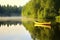 yellow canoe floating on a serene pond with reflections
