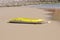 Yellow canoe lying on the beach