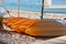 Yellow canoes on the beach.Close-up of several kayaks drying in the sun