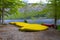 Yellow canoes in a row on the beach of Bohinj lake