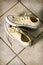 Yellow canvas running shoes on a tile floor.