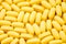Yellow capsules pills big heap