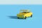 Yellow car casting shadow on blue background