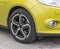 Yellow car closeup - front wheel with light alloy rim