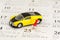 Yellow car model and a red pushpin on Chinese calendar