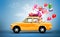 Yellow car with symbols of love, holiday, happyness and travel.