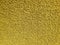 Yellow carpet roll covering. Polypropylene long pile carpet texture background. Top view