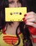 Yellow Cassette Tape With Woman in Retro clothing in background