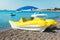 The yellow catamaran is on the beach