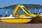 Yellow catamaran on the beach. Preparation for the beach season. Entertainment at sea.