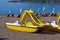 Yellow catamaran on the beach. Preparation for the beach season. Entertainment at sea.