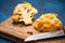 Yellow Cauliflower Cabbage on Cutting Board. Market Fresh Organic Food. Plant Based Diet