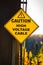 A yellow Caution High Voltage Cable sign