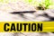 Yellow Caution sign, hazard tape to improve worksite safety.