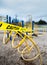 Yellow caution tape surrounding climbing apparatus in closed public playground during Coronavirus Covid-19 pandemic