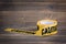 Yellow caution tape on a wooden background. Safety Barrier For Police Barricade, For Contractors