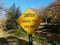 Yellow caution winding trail keep right sign near river