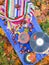 Yellow ceramic cup of herbal tea and vinyl records on aged wooden background with fall autumn leaves and chestnuts