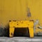 Yellow chair in front of the yellow wall, grunge background