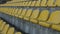 Yellow chairs in an empty stadium, slow motion 120 fps