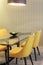 Yellow chairs with glass table in dinning room