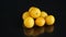 Yellow cherry plums on the black background