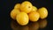 Yellow cherry plums on the black background