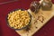 Yellow chickpeas lie in an oriental plate on a wooden spice board