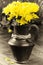 Yellow chrysanthemums in a vintage jug