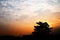 Yellow cloudy sky with city silhouette in sunset hour