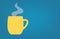 Yellow coffee cup with steam and copy space