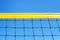 yellow colored summer games ball background beach volleyball or tennis net against blue sky for sport events. copyspace. copy