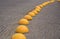 Yellow concrete hemisphere - anti-parking stop on old paving stones of square