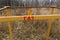 Yellow concrete pillar with a warning sign Gas, outdoors in the grass. Gas pipes, valves and devices for a gas pumping station Gas