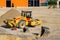 Yellow construction roller on a construction site. Excavator buckets on the ground