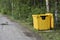 Yellow container for collecting garbage in the public forest park in Yekaterinburg city, Russia