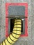 Yellow cooling airconditioning hose or pipe out of tarmac ground point with red lines connected to underside of airplane