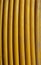 Yellow copper cable in a vertical coil
