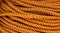 Yellow cord background close-up photo. Braided rope texture. Ship rock climbing tackle. Natural material woven cordage