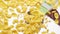 Yellow corn flakes falling from package on a transparent background, bottom view.