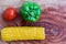 Yellow corn stalk with tomato and capsicum close up photo in wooden background