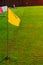Yellow corner flag on the green football field