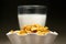 Yellow cornflakes and milk glass