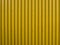 Yellow corrugated wall. Yellow steel background. Mounted with screws. Can be used as a background.
