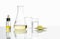 Yellow cosmetic liquid in Dropper Bottle, Poly Aluminium chloride liquid in Erlenmeyer flask, Crystal clear liquid in beaker and