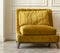 Yellow cozy armchair in a white interior. Close-up