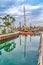 Yellow crane and docks on canal in Long Beach California against cloudy blue sky