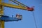 Yellow crane in the harbor of Amsterdam unloading a ship