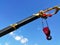 Yellow crane hook While working This shot was taken from a bottom up view, allowing the background to see a bright sky.